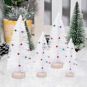 Detailed view of four mini white bottle brush trees with colorful ornaments and wood bases