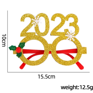 Glittery 2023 New Year glasses with snowflakes and holiday leaves on a white background