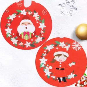 Detail view showing clear Santa Claus and girl prints on festive red Christmas placemats