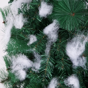 Artificial Christmas tree branches with green PVC needles and thick white decorative snow