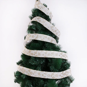 White Christmas ribbon with gold glitter snowflakes wrapped on a green pine tree