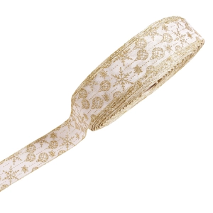 Detail of white Christmas ribbon with gold glitter snowflake and ornament patterns