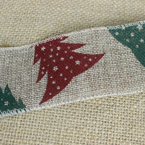 Close-up of burlap Christmas ribbon featuring red and green printed trees with white snowflakes