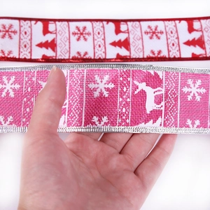 Red and pink Christmas ribbons with snowflake and reindeer patterns for tree decoration