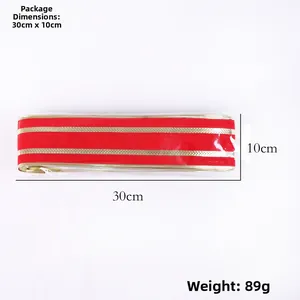 Macro shot of 10m red velvet Christmas ribbon with gold edges in 30x10cm packaging