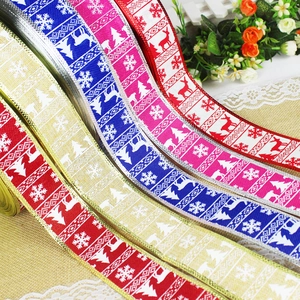 Detailed view of assorted Christmas ribbons with snowflake and reindeer patterns