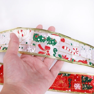 Detail of Christmas ribbon with snowman trees prints and golden wired edges