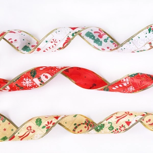 Close-up of festive Christmas ribbons with gold edges, snowman and Santa patterns