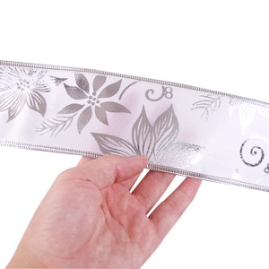 Detail view of 10m white Christmas ribbon with silver floral print and satin texture