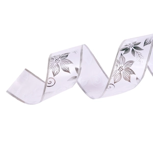 White Christmas ribbon with silver flower print and shimmering stitched edges in spiral