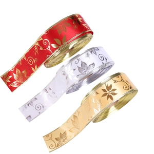 Detailed view of red, white, and gold Christmas ribbons with poinsettia flower prints