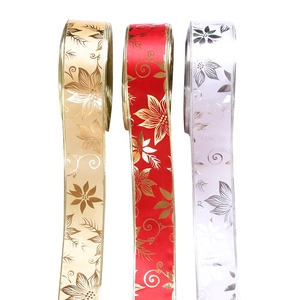 Detailed view of red, gold and white Christmas ribbons with glittery floral patterns