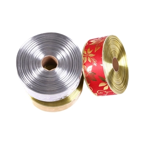 Detailed view of 10m metallic gold, silver and floral red Christmas ribbons for gift wrapping
