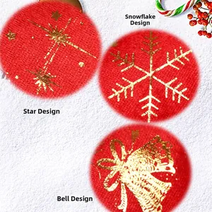 Detailed view of red knitted fabric swatches with golden star, snowflake, and bell prints