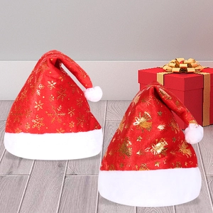 Detail of red Christmas hats with golden snowflake prints and white plush trim