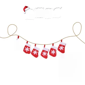Detail of red Christmas sock bunting with white snowflakes and 3m twine rope