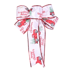 Detail of white satin Christmas bow featuring red vintage truck and tree patterns