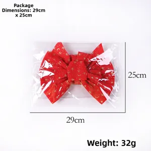 Detail view of large red velvet Christmas bow with gold patterns and 29x25cm size specs