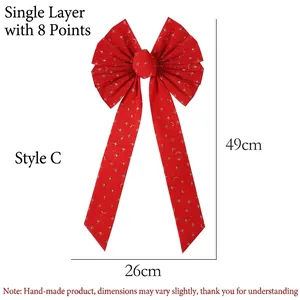 Detail of red velvet Christmas bow with gold glitter stars and moon patterns, 49x26cm size