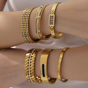 Stack of gold-plated stainless steel bangles with geometric zircon and weave textures