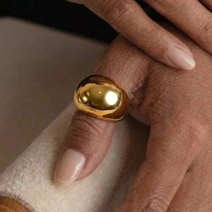Polished 18k gold plated stainless steel dome ring featuring a smooth geometric surface