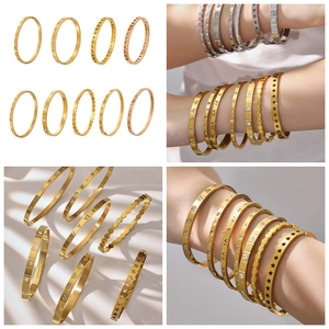 Detailed macro of 18k gold plated stainless steel bangles with Roman numerals and zircons