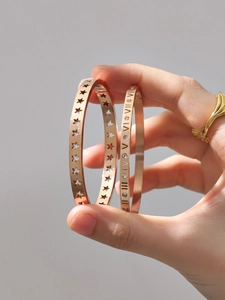Detail of 18K gold plated hollow stars and Roman numeral bracelets with zircon