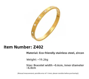 Detailed view of gold plated stainless steel bangle showing inner stamp and CZ stone settings