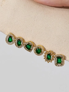 Detail of six-pair green gemstone stud earrings set in vintage gold-plated finish