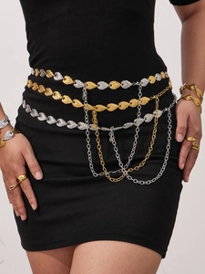 Detail view of a layered gold and silver leaf body chain with dangling fringe tassels