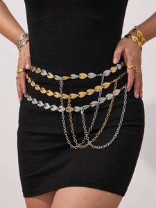 Detail of multi-layered gold and silver body chain with geometric leaf-shaped textures