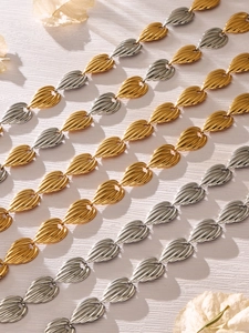 Detailed view of gold and silver teardrop chain links with textured radial patterns