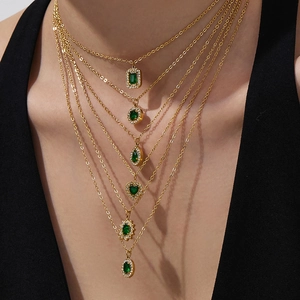 6-layer layered gold necklace with emerald green gemstone pendants and zircon accents
