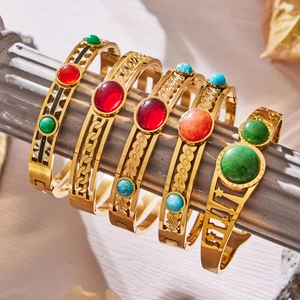 Five gold-plated geometric bangles set with natural red agate and colorful stones on stone pillars