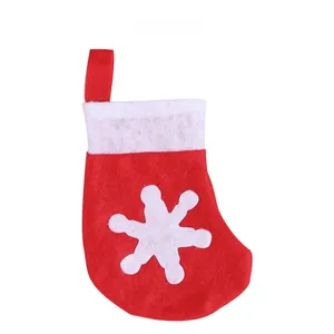Detail of red Christmas stocking with white snowflake and hanging loop for tree decoration