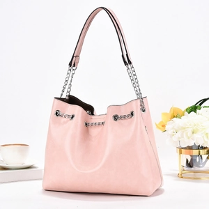 Pink pleated shoulder bag with silver chain strap and large capacity in a stylish setting