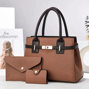 Detailed set of orange woven tote bag with matching clutch and purse on a desk