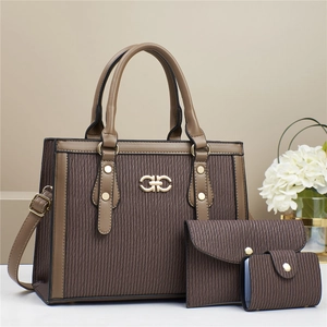 Detailed macro view of the brown three-piece handbag set with elegant pleated texture