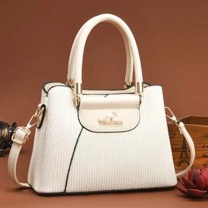 Elegant cream textured handbag with three compartments and adjustable gold hardware strap