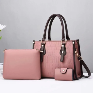 Pink crocodile pattern tote bag set with brown handles and elegant gold hardware details