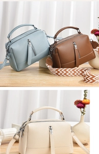 Detailed view of women's leather crossbody bags in blue, brown, and cream with wide straps