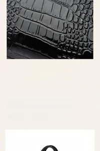 Detail of the high-gloss black crocodile embossed texture on a large capacity tote bag