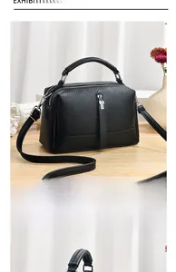 Detail view of black litchi texture small square bag with dual metal zippers and single handle