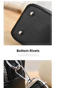 Detail of black pebbled leather bag with silver base rivets and metal strap hooks