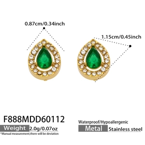 Detail of tear drop earrings with green zircon in gold plated stainless steel
