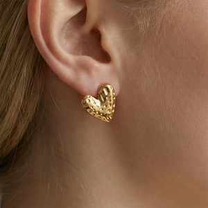 Hammered texture 18k gold plated heart stud earrings worn by model for a minimalist look