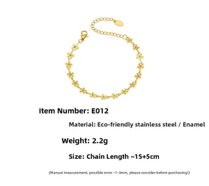 Detail of 18k gold plated stainless steel bracelet with turquoise flower daisy charms