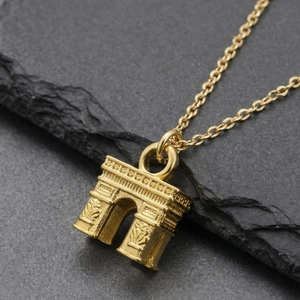 18k gold plated stainless steel necklace with Arc de Triomphe pendant on stone background