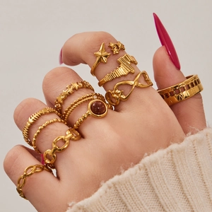 Set of ten gold geometric stainless steel rings featuring stars and Roman numerals