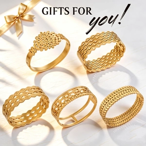 Detail view of five assorted gold-tone stainless steel bracelets with intricate openwork patterns